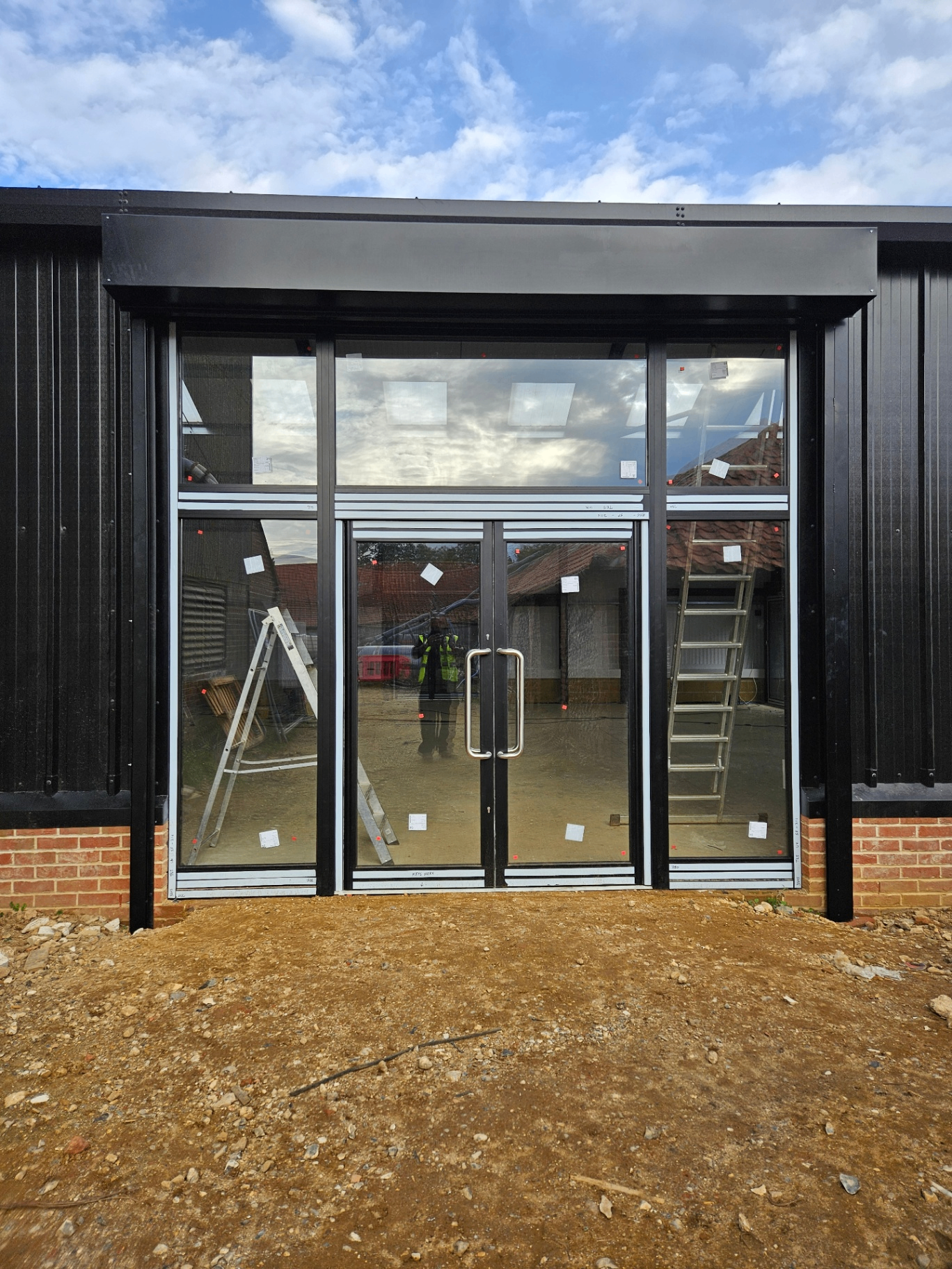 Black aluminium shopfront with double doors – Prestige Aluminium Systems